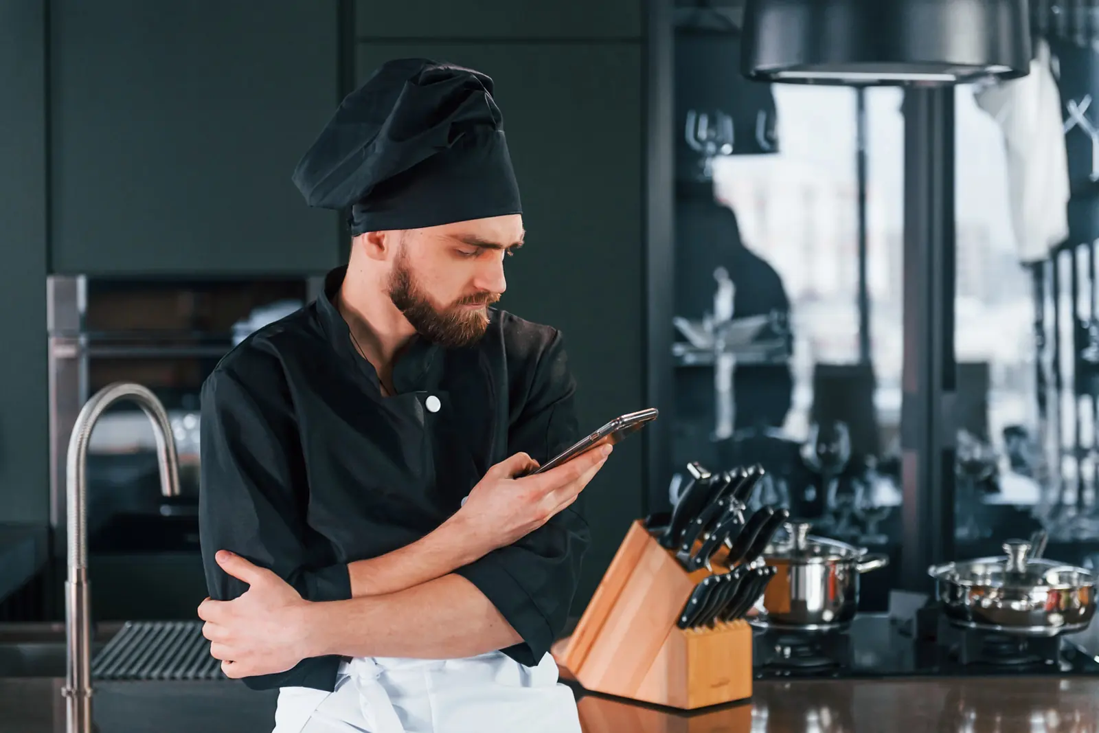 A chef checks his phone mid-shift