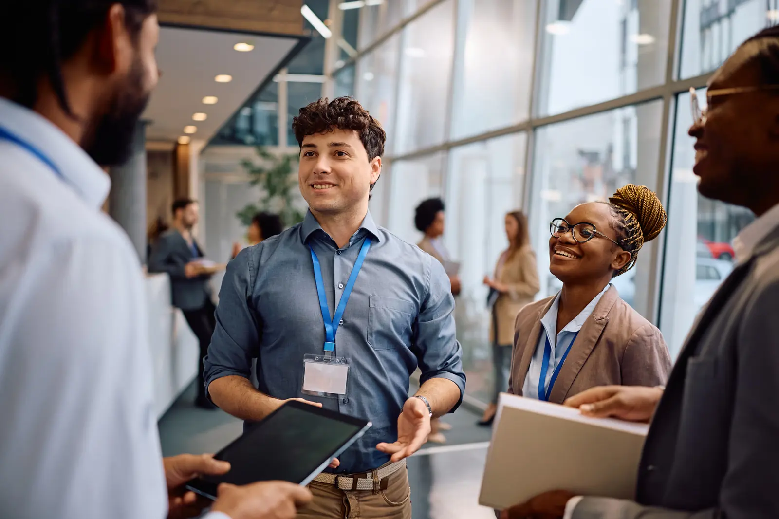 Attendees talking in a convention hallway